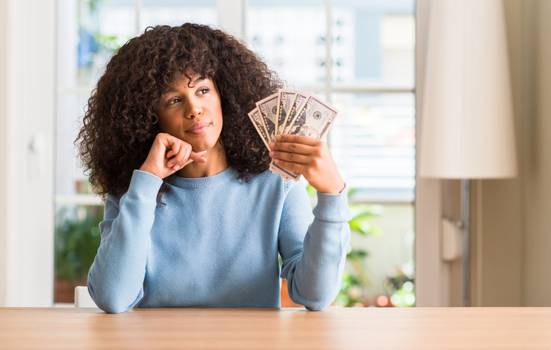 protect your assets during divorce: african american woman counting money