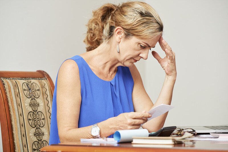 single mothers and retirement: worried older woman looking at budget