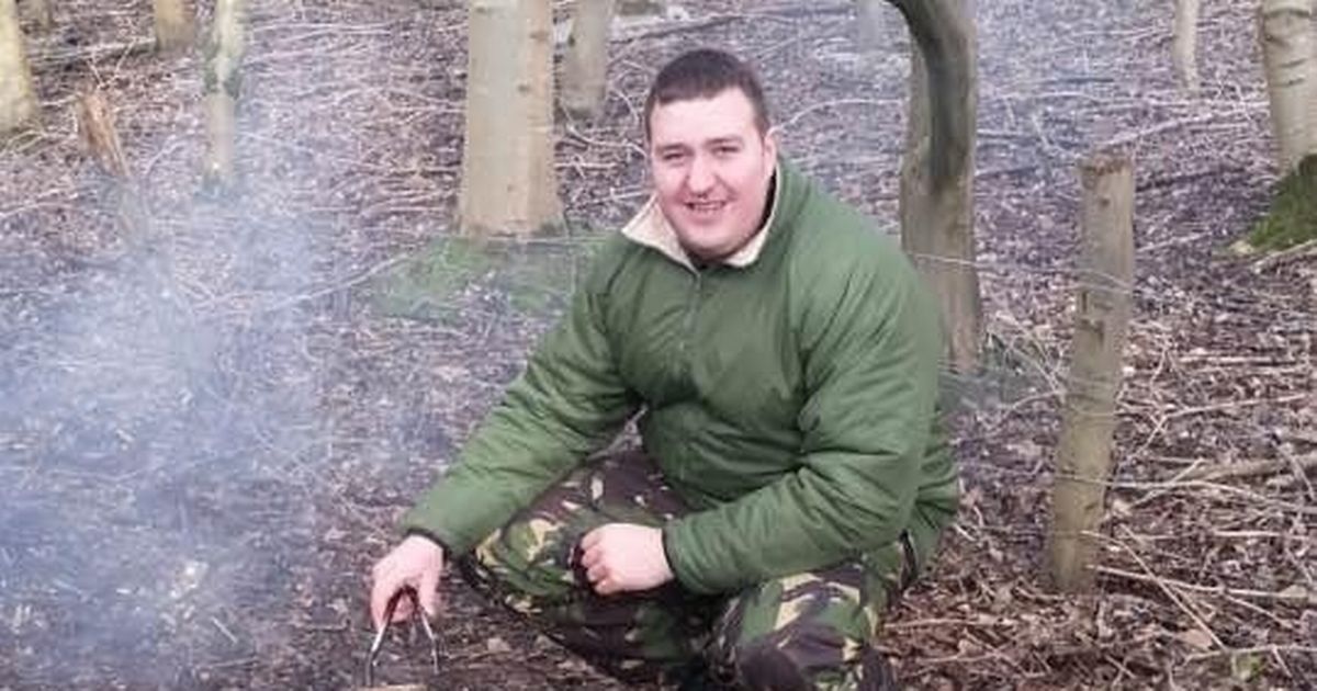 A photo of veteran Gavin Briggs, cooking in a woodland